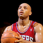 A close-up of Charles Barkley's face; he is smiling broadly and is wearing a white shirt.