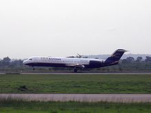 IRS Airlines Fokker 100 landing Abuja.JPG